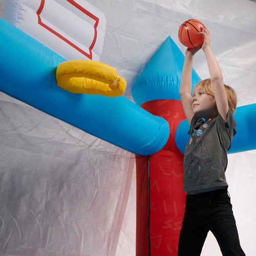 Child playing basketball in front of an inflatable hoop