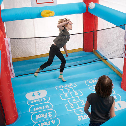 Children playing in an inflatable boxing ring with a blue and red design.