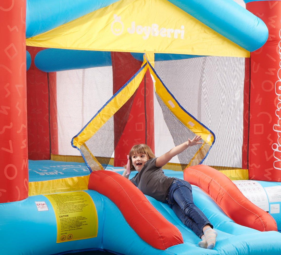Child playing on a colorful inflatable slide with 'JoySurf' branding.