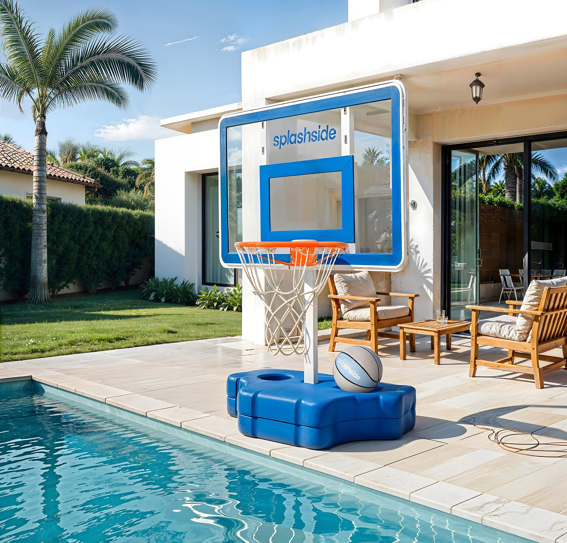 Poolside basketball hoop with 'splashside' branding next to a pool and patio area.